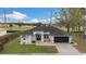Aerial view of a charming one-story home with manicured lawn and convenient driveway at 6140 Silver Oaks Dr, Zephyrhills, FL 33542