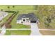 Birds-eye view of a beautiful one-story home with a landscaped yard and driveway at 6140 Silver Oaks Dr, Zephyrhills, FL 33542