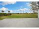 Expansive back patio with large open grassy area and view at 6140 Silver Oaks Dr, Zephyrhills, FL 33542
