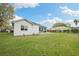 View of the home's backyard featuring a patio and a well-maintained lawn at 6140 Silver Oaks Dr, Zephyrhills, FL 33542