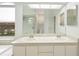 Bright bathroom featuring double vanity, tub, and glass-enclosed shower, providing a spa-like experience at 6140 Silver Oaks Dr, Zephyrhills, FL 33542