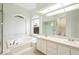 Bright bathroom featuring a walk-in shower, separate soaking tub, and dual vanity at 6140 Silver Oaks Dr, Zephyrhills, FL 33542