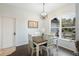 Dining area with pendant lighting, table with four chairs, and a large window with a view at 6140 Silver Oaks Dr, Zephyrhills, FL 33542
