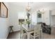 Dining area with pendant lighting, table with four chairs, and a large window at 6140 Silver Oaks Dr, Zephyrhills, FL 33542