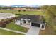 Aerial view of a single-Gathering home with a well-manicured lawn, driveway, and attached two-car garage at 6140 Silver Oaks Dr, Zephyrhills, FL 33542