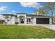 Charming single-story home with a well-manicured lawn and a two-car garage at 6140 Silver Oaks Dr, Zephyrhills, FL 33542