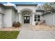 Elegant home entrance with decorative double doors and manicured landscaping at 6140 Silver Oaks Dr, Zephyrhills, FL 33542