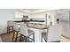 Bright kitchen with white cabinetry, granite counters, stainless steel appliances, and bar stool seating at 6140 Silver Oaks Dr, Zephyrhills, FL 33542