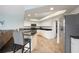 Bright kitchen with white cabinetry, granite counters, stainless steel appliances, and bar stool seating at 6140 Silver Oaks Dr, Zephyrhills, FL 33542