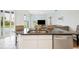 Kitchen island with a granite countertop, stainless steel appliances, and natural light at 6140 Silver Oaks Dr, Zephyrhills, FL 33542