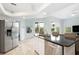 Kitchen island with a granite countertop, stainless steel appliances, and natural light at 6140 Silver Oaks Dr, Zephyrhills, FL 33542