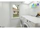 Neat laundry room featuring washer and dryer, ensuring convenience in your daily chores at 6140 Silver Oaks Dr, Zephyrhills, FL 33542