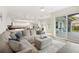 Spacious open-concept living room with large sectional sofa and a view of the outdoor patio at 6140 Silver Oaks Dr, Zephyrhills, FL 33542