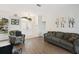 Cozy living room with hard floors, leading to a bright entryway with double doors at 6140 Silver Oaks Dr, Zephyrhills, FL 33542