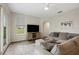 Bright living room with hardwood floors, sectional sofa, and access to the backyard at 6140 Silver Oaks Dr, Zephyrhills, FL 33542