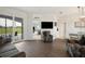 Open-concept living room with patio access and view into the dining area at 6140 Silver Oaks Dr, Zephyrhills, FL 33542