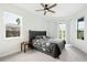 Inviting main bedroom with a queen size bed, two windows and neutral tones at 6140 Silver Oaks Dr, Zephyrhills, FL 33542