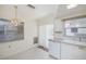 Well-lit kitchen with white cabinetry, sleek countertops, and bright lighting at 7847 39Th N Ter, St Petersburg, FL 33709