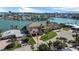 Stunning aerial view of waterfront home with lush landscaping, boat dock, and panoramic views of the bay at 7986 9Th S Ave, St Petersburg, FL 33707