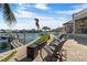 Seaside backyard with pool, dock, and waterfront access, creating an ideal outdoor retreat at 7986 9Th S Ave, St Petersburg, FL 33707