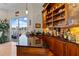 Wet bar with custom cabinets and granite countertop and access to the outdoor dock at 7986 9Th S Ave, St Petersburg, FL 33707