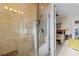 Luxurious bathroom with stone tile shower, glass door, and neutral color palette at 7986 9Th S Ave, St Petersburg, FL 33707