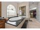Bathroom boasting a modern tub and glass-enclosed shower, illuminated by a arched window and complemented by black countertops at 7986 9Th S Ave, St Petersburg, FL 33707