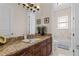 Bathroom vanity featuring granite countertop, decorative plants, and modern fixtures at 7986 9Th S Ave, St Petersburg, FL 33707