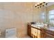 Elegant bathroom featuring tile floors, vanity with granite countertop and large mirror at 7986 9Th S Ave, St Petersburg, FL 33707