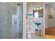 Elegant bathroom with a glass shower, blue glass vessel sink, and decorative tile accents at 7986 9Th S Ave, St Petersburg, FL 33707