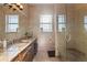 Luxurious bathroom with granite countertops, a glass shower, and natural lighting at 7986 9Th S Ave, St Petersburg, FL 33707