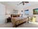 Cozy bedroom with water views, complemented by a comfy chair, a dark wood bed frame, and beach-themed decor at 7986 9Th S Ave, St Petersburg, FL 33707