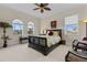 Bedroom with large windows, ceiling fan, and decorative accents at 7986 9Th S Ave, St Petersburg, FL 33707
