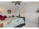 Bedroom with decorative bed frame, adjacent doors, and neutral color scheme at 7986 9Th S Ave, St Petersburg, FL 33707