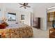 Bright bedroom with large window offering water views, complemented by a wooden dresser and a cozy reading nook at 7986 9Th S Ave, St Petersburg, FL 33707