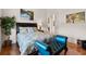Bedroom with hardwood floors, blue accents, and decorative artwork at 7986 9Th S Ave, St Petersburg, FL 33707