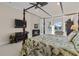 A luxurious bedroom boasts a canopy bed, fireplace, and scenic water views from the bay window, blending comfort with elegance at 7986 9Th S Ave, St Petersburg, FL 33707
