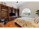Bedroom featuring custom wood bookcase, large window, and hardwood floors at 7986 9Th S Ave, St Petersburg, FL 33707