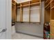 Walk-in closet featuring custom wooden shelving and metal rods for ample storage at 7986 9Th S Ave, St Petersburg, FL 33707