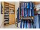 Walk-in closet features custom shelving, and hanging storage for clothing and accessories at 7986 9Th S Ave, St Petersburg, FL 33707