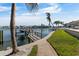 Private boat dock with boat lift along manicured lawn creates a waterfront haven at 7986 9Th S Ave, St Petersburg, FL 33707