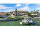 Waterfront home featuring a private boat dock, a lush yard, and a swimming pool with beautiful balconies overlooking the water at 7986 9Th S Ave, St Petersburg, FL 33707