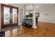 Grand foyer featuring hardwood floors, decorative columns, and a view into the dining and living spaces at 7986 9Th S Ave, St Petersburg, FL 33707
