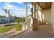 Inviting covered entryway featuring brick flooring, stately columns, and views of the landscaped front yard at 7986 9Th S Ave, St Petersburg, FL 33707