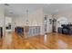 Hallway with hardwood floors, decorative railing, and views into other rooms at 7986 9Th S Ave, St Petersburg, FL 33707