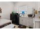 Well-lit laundry room with modern washer and dryer, white cabinets, and sink, creating a functional space at 7986 9Th S Ave, St Petersburg, FL 33707