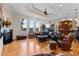 Spacious living room with a fireplace, hardwood floors, a wet bar and picturesque water views at 7986 9Th S Ave, St Petersburg, FL 33707