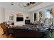 Spacious living room with a fireplace, hardwood floors, tray ceilings, and beautiful waterfront views at 7986 9Th S Ave, St Petersburg, FL 33707