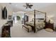 Primary bedroom with fireplace, sitting area, and waterfront views at 7986 9Th S Ave, St Petersburg, FL 33707