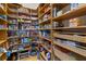 Walk-in pantry with custom wood shelving and basket storage at 7986 9Th S Ave, St Petersburg, FL 33707